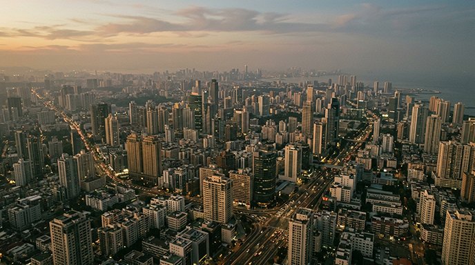 Aerial view of a dense city skyline at dusk