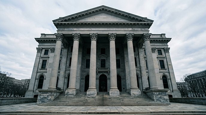 Exterior of a grand neoclassical government building with large columns